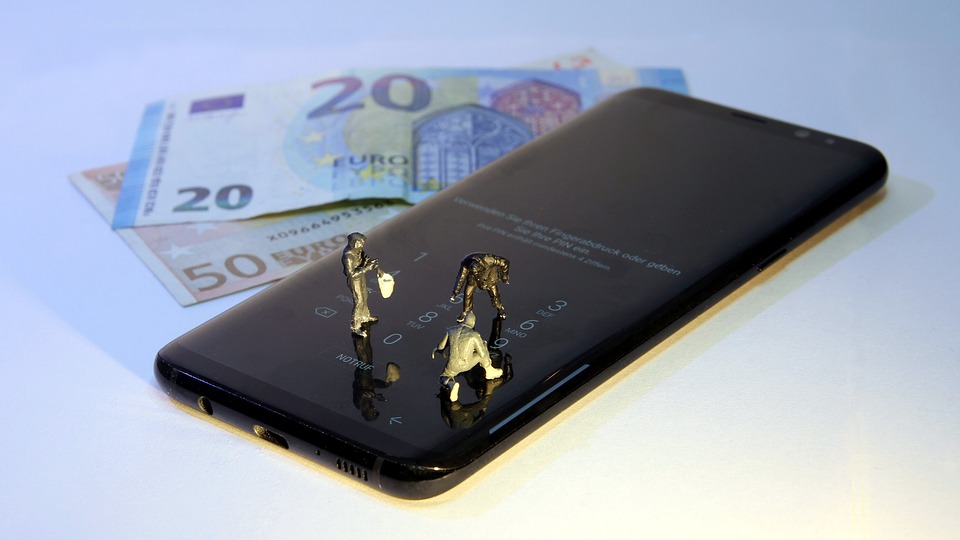 Three small statuettes arranged on a phone lock screen, as if they were mining it.