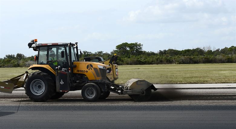 A Steamroller flattening pavement.